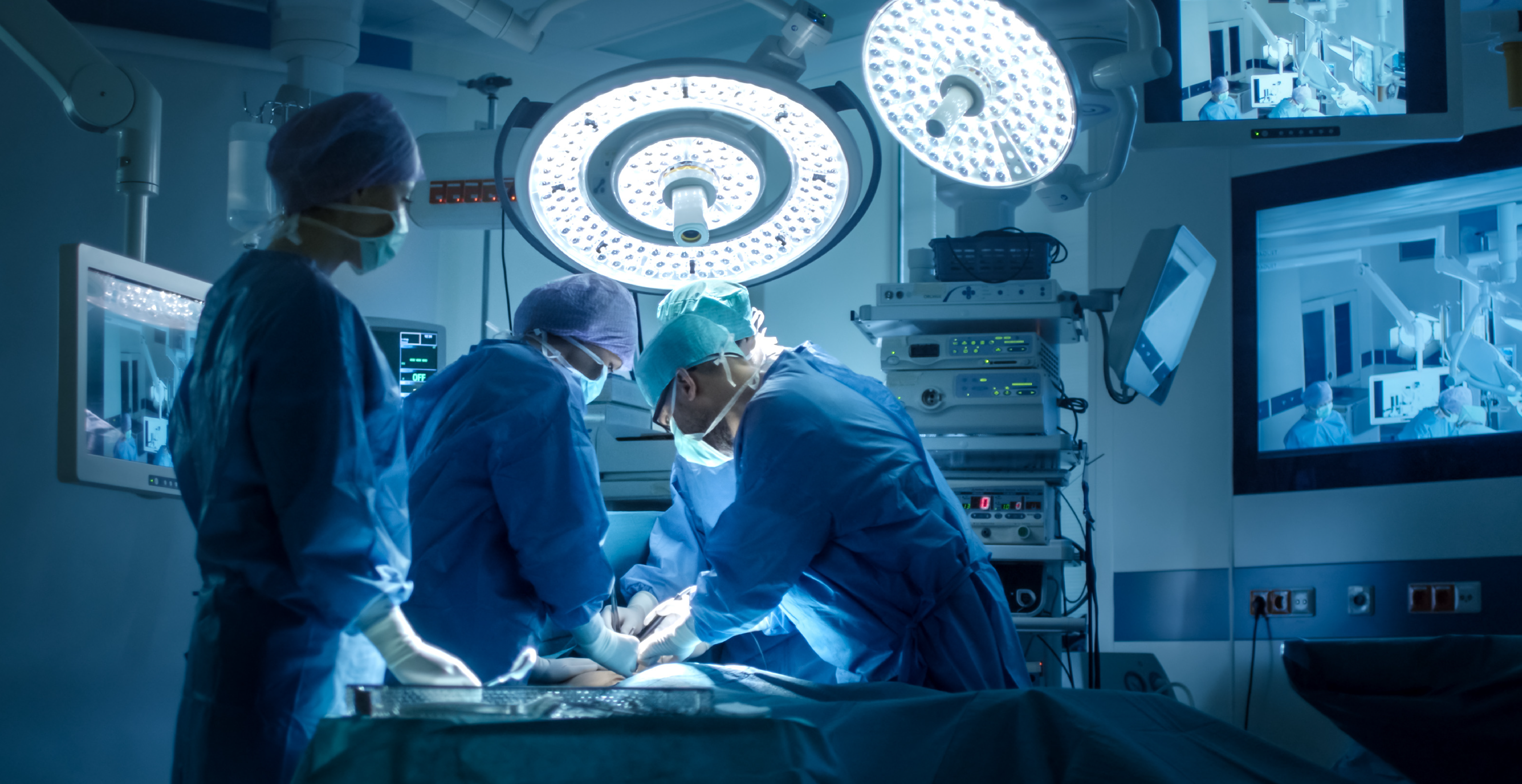Surgeons performing surgery in operating room